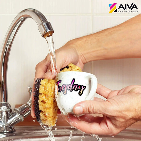Washing a mug labeled 'Tuesday' under running water