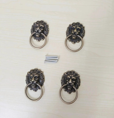 Antique Bronze Lion Head Ring Pull Cabinet Handles Set Of 4 With Screws, 2.6 Inches Long By 1.6 Inches Wide on light surface