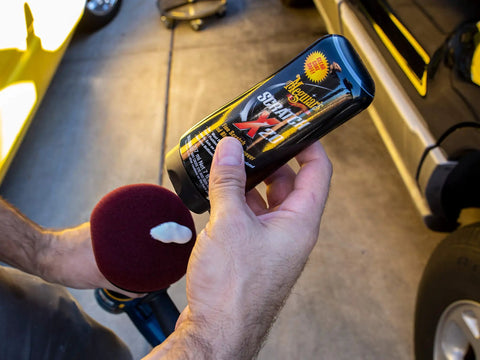 Car Scratch Fix That Kicks Out Paint Scratches and Swirls Without Messing Your Clear Coat Meguiars ScratchX 7 Oz Liquid in hand, showing label.