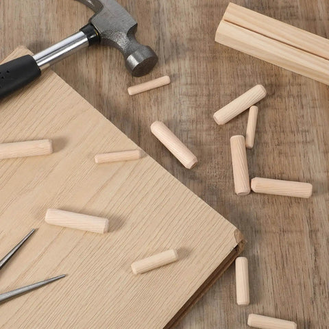 Thirty Piece Wood Dowel Set With One Quarter Inch, Three Eighths Inch, And Five Sixteenths Inch Hardwood Fluted Dowels on table