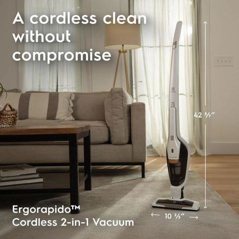 Electrolux Ergorapido cordless 2-in-1 vacuum cleaner in satin white, upright on rug beside sofa