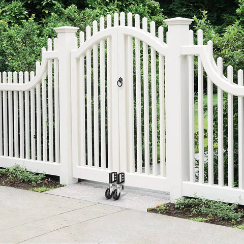 Hidden Spring Gate Wheels For Wooden Gates Heavy Duty Gate Casters With Spring Loaded Shock Absorber 4 Inch Black Wheels Supports Up To 220 Lbs Quiet Smooth Operation On Rocky Driveways And Uneven Terrain For Farm Fences attached to a white gate.
