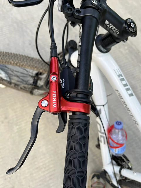 Red WIROJ hydraulic disc brake lever, left-front mounted on MTB handlebar with black grip and hose