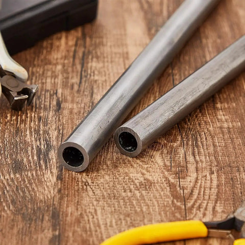 Two Pack Three Quarter Inch Cold Rolled Steel Tubes Seamless Round Tubing Heavy Duty Built To Last 6 Inch Length on wooden table