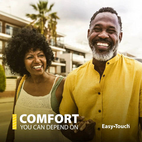 Man and woman smiling outdoors, text "Comfort You Can Depend On Easy-Touch" visible. Casual attire. Sunny day.