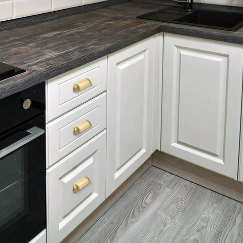 Brushed Matte Gold Brass Cabinet Drawer Pulls Pack Of Two And A Half Inch Center To Center Solid Knobs installed on white kitchen cabinets.