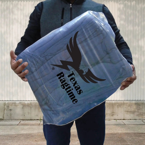 Man holding package of Blue Industrial Cloth Rags for Auto Mechanics and Janitorial Work, Heavy Duty, Low Lint, Durable and Reusable