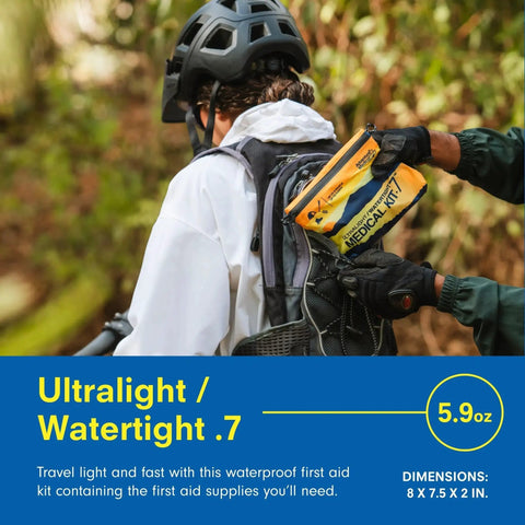 Person holding Ultralight Waterproof Medical Kit For Up To 3 People And 3 Days With DryFlex Bag on a forest hike