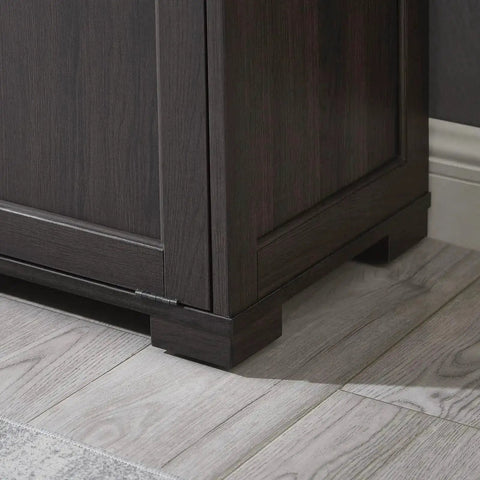 Corner view of wooden tilt out trash cabinet with espresso finish on tiled floor, part of the Tilt Out Trash Cabinet Wooden focus keyword