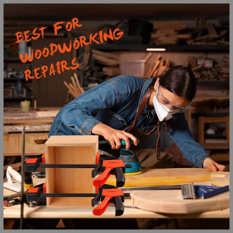 Two Pack 6 Inch Bar Clamps For Woodworking Ready To Grab And Go Quick Grip Release Heavy Duty F Clamp And Spreader Trigger Clamp With 150 Lbs Load Limit clamping a wooden box on a workbench with tools around, person sanding wood in background.