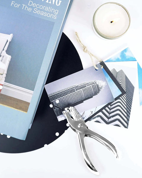 Circle Hole Punch Set Two Piece One Eighth Inch And One Quarter Inch Single Hole Punchers for crafts next to photos and candle