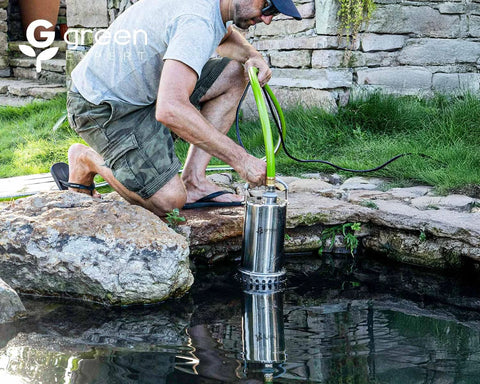 Green Expert 1HP stainless steel submersible sump pump 4000GPH with 25ft cord and green hose in a garden pond.