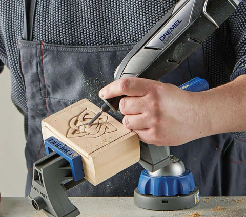 Person using 12V Cordless Rotary Tool Kit With Variable Speed And Ergonomic Comfort Grip, Includes 2Ah Battery, Charger, 5 Accessories, Wrench, And Fabric Carry Bag For Portable DIY Task Mastery By Dremel to carve wood