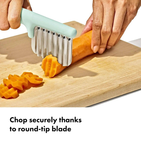 Crinkle Cutter For Kids Safe Food Prep And On The Go Mealtime Fun With Easy Grasp Shapes For Babies And Toddlers OXO Tot Crinkle Cutter Great For Little Hands And Picky Eaters Durable Plastic Dishwasher Safe For Easy Cleaning On The Go cutting carrot on board
