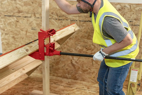 Portable Wall Jack 1000 Lb Capacity For Raising Walls And Beams in use on construction site for lifting wooden structures.