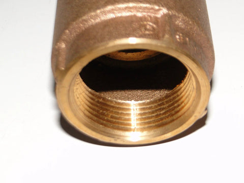 Brass 1-inch no-lead check valve, close-up of threaded inlet, for water well pump installations.