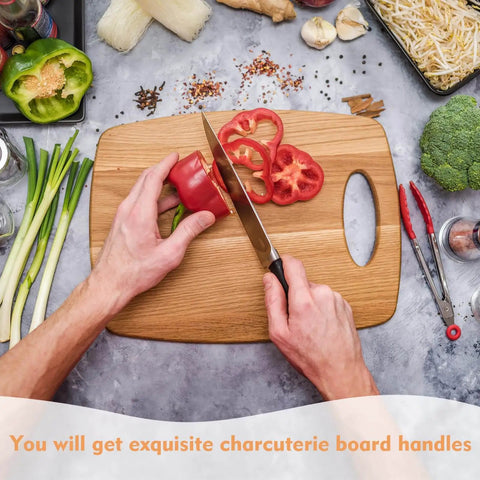 Person using knife on wooden cutting board with grab handles, surrounded by vegetables.