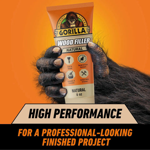All Purpose Wood Filler Natural Color 6 Ounce Tube pack held by a gorilla hand with high performance label, for indoor and outdoor repairs.
