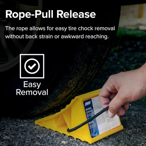 Person using rope to remove Two Pack Heavy Duty RV Wheel Chocks With Rope For Trailers Up To 26 Inches from under tire.