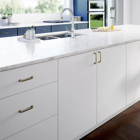 White kitchen cabinets with Champagne Bronze Cabinet Pulls 4 Inch Center To Center 5 Pack Drawer Handles, zinc finish installed.
