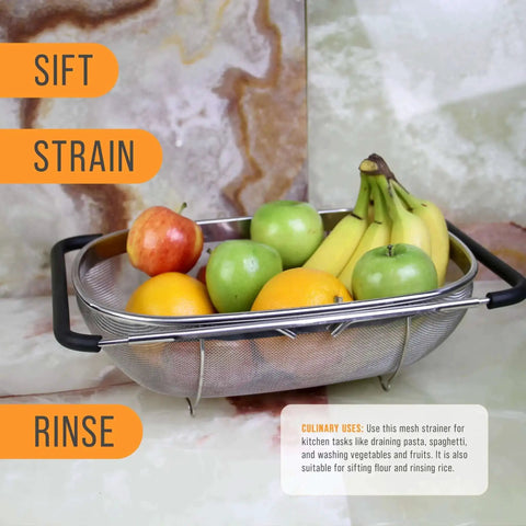 6-Quart Over The Sink Stainless Steel Colander With Expandable Rubber Handles filled with assorted fruits on a marble surface