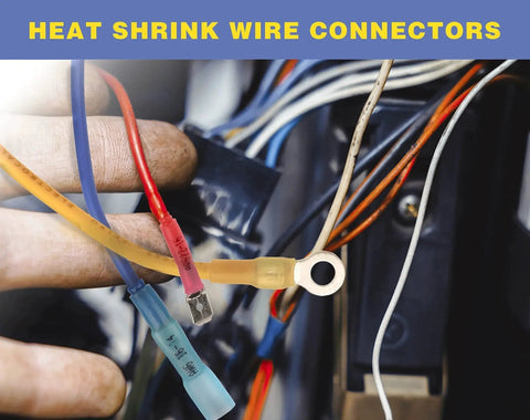 Close-up of heat-shrink butt connectors on blue and yellow wires with a crimped metal ring terminal