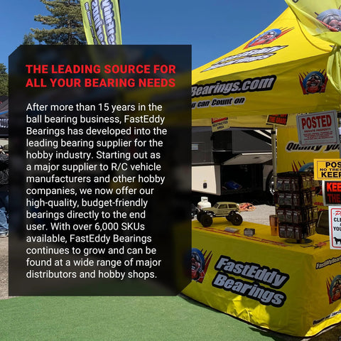 FastEddy Bearings compatible with Traxxas Slash ceramic bearing kit on display at a booth with a yellow canopy and RC cars.