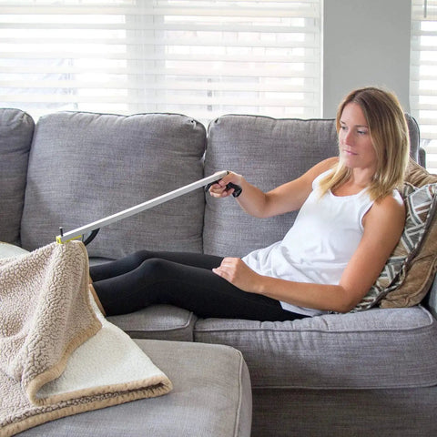 Extended Reach Reacher Tool For Easy Grabs And Recovery By DMI Claw Grabber For Elderly And Disabled Reaching Assist To Pick Up Trash Or From The Floor 32 Inch Non Folding Magnetic Claw Hand Gripper Arm Extension used by woman on couch.