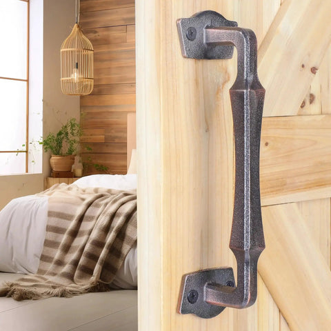10 Inch Heavy Duty Rustic Sliding Barn Door Pull Handle In Oil Rubbed Bronze Finish installed on wooden door indoors.
