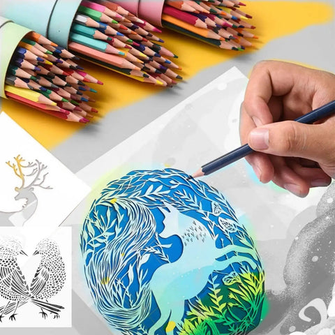 Hand holding pencil beside colorful stencil artwork, surrounded by colored pencil sets, depicting a unicorn design.