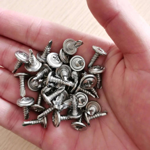 Hand holding 410 Stainless Steel Self Drilling Screws Assortment Kit With Wafer Head Phillips Drive Tek Screws For Sheet Metal Modified Truss Head
