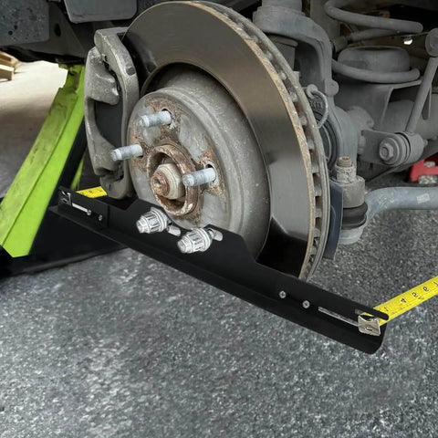 Pro Grade Wheel Alignment Tool Kit With Tape Measures, Heavy Duty Toe Alignment Plates installed on car wheel hub.