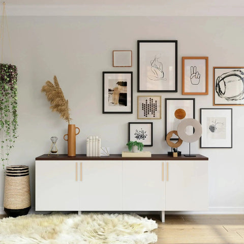 White cabinet with art frames above, featuring Ten Pack 5 Inch Center To Center Zinc Alloy Champagne Bronze Kitchen Cabinet Handles Drawer Pulls.
