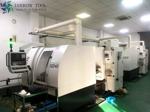 Row of CNC machines in a workshop setting, showing equipment used for precision machining.