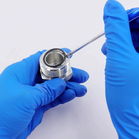 Blue-gloved hands using pick tool on fitting with Pro Grade Hydraulic O Ring Kit With 420 Pieces For ORS ORFS Fittings