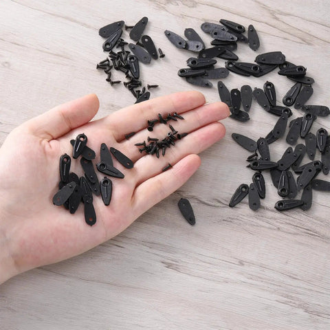 Hand holding 100 Pcs Metal Picture Frame Turn Button Fasteners with 100 Pcs Screws Black Backing Clips for Picture Frames Repair Kit