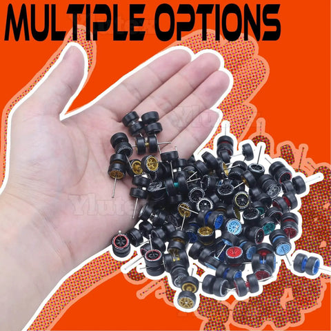 Hand holding 1/64 Scale Diecast Car Wheels And Tires Set Mixed Random Realistic Wheel Rims With Printed Detail For Customizing Cars Variety Pack For 1/64 Models Great For Collectors And Hobbyists on orange background.