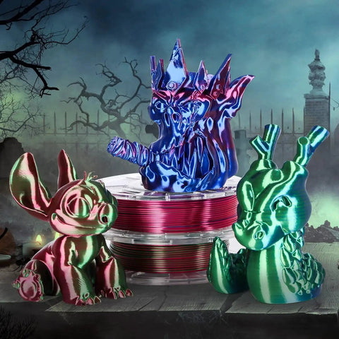 Silk Dual Color PLA Filament Bundle 4x200g 1.75mm For 3D Printers in multicolor, with 3D printed figures in front of spooky background.