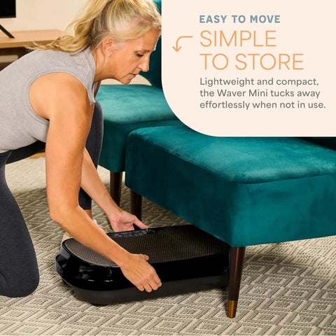 Woman storing Waver Mini Vibration Plate For Full Body Toning And Lymphatic Drainage under sofa