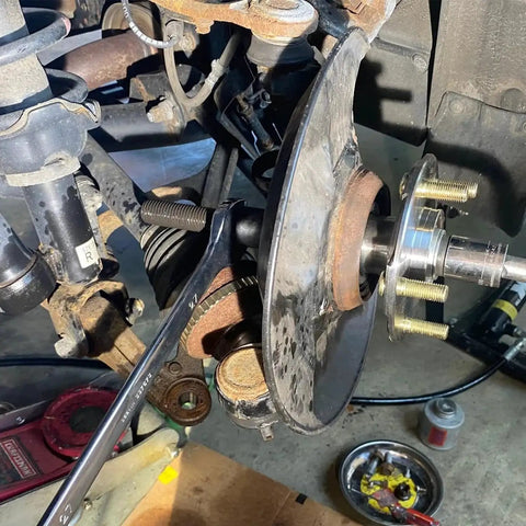 Wheel Bearing Removal And Installation Tool Kit For Front Rear And All Wheel Drive Vehicles with hub puller in use on suspension