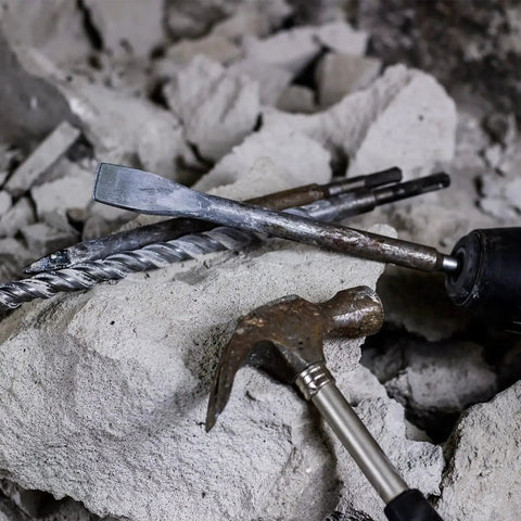 Carbide-Tipped SDS-Plus Rotary Hammer Drill Bit Set YOUGFIN 17 Pieces on concrete with chisel and hammer