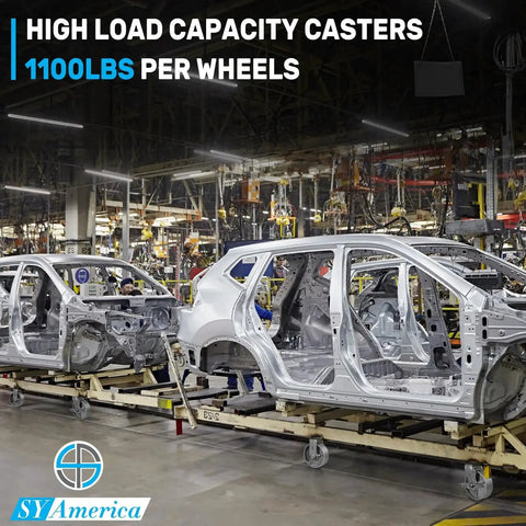 Automobile frames on platform trucks in factory with Heavy Duty Cast Iron Caster Wheels Set Of Four 5 Inch By 2 Inch Swivel Casters