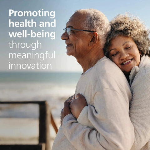 Elderly couple smiling and embracing, promoting health and well-being through meaningful innovation text in background.