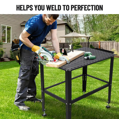 Man using Beefy Heavy Duty 36x24 Welding Table With Five Eighth Inch Tool Holes And Adjustable Legs 1500 Pound Steel Fabrication Workbench For Welding Sawing Auto Repair And Fixturing in garden