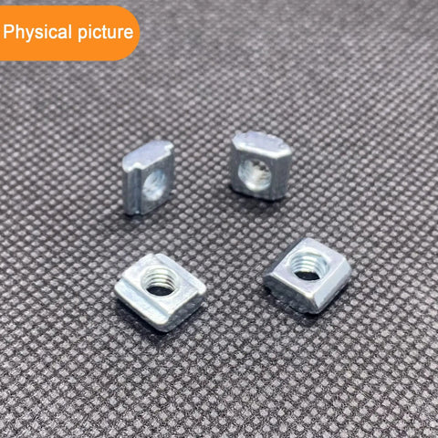 100 Pack 2020 Series Sliding T Nuts M5 Thread Hammer Head For 6mm T Slot Aluminum Extrusion, four nuts on textured surface.