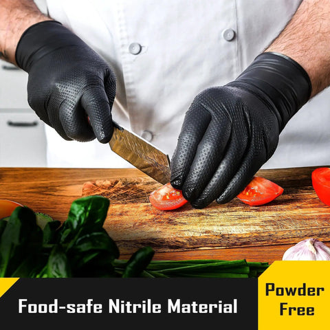 Chef wearing 8 Mil Disposable Nitrile Gloves With Diamond Textured Grip 100 Count cutting tomatoes on wooden board.