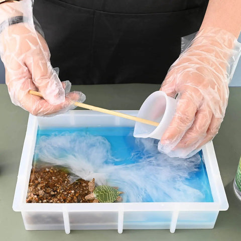 Craftsperson using 9 Inch Rectangular Silicone Molds For Epoxy Resin Deep Casting Crystal Mold For Flower Preservation DIY Artwork