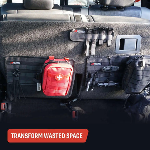 Car interior with Tech Panel Small 2.5 By 9.5 Inch Universal Vehicle MOLLE Organizer holding pouches and gear on back seat.