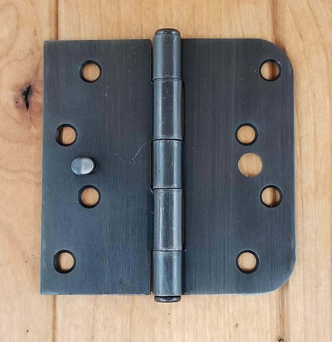 Oil Rubbed Bronze Security Door Hinges Four Inch With Five Eighths Inch Radius Security Tab Pack Of Two Includes Matching Wood Screws Anti Removal For Residential And Commercial Doors Ideal For Entry And Exterior Doors With Tamper Resistant Design installed on wood surface