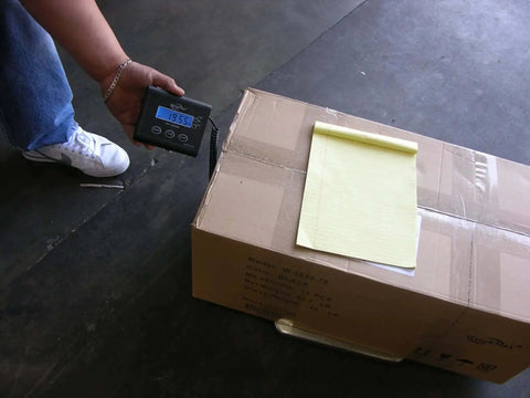 Digital Wireless Postal Scale With 330 Lb Capacity For Shipping And Packaging Industrial Grade Weighing Solution Battery And Adapter Included Beast For Post Offices Warehouses And Manufacturing Environments displaying weight of a package on a warehouse floor.